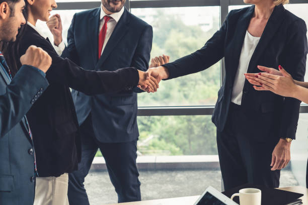 istock Business people handshake in corporate office 1259423626