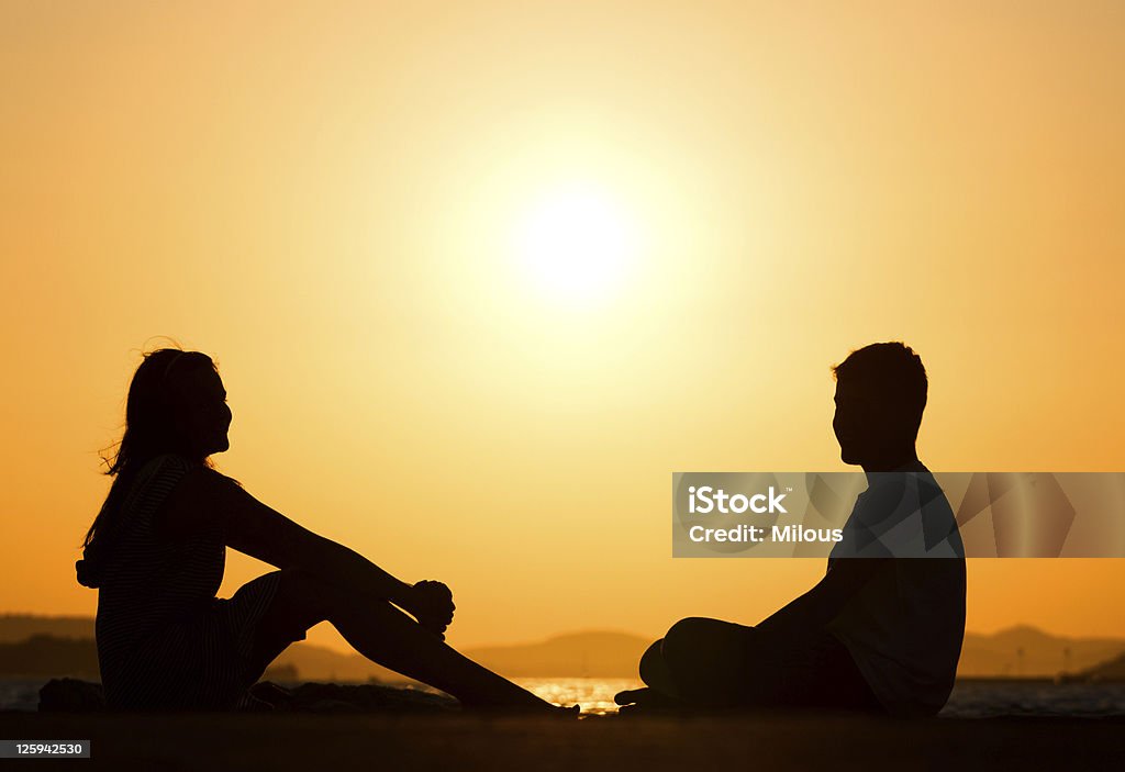Young friends during sunset Silhouette picture of young friends during sunset Adult Stock Photo