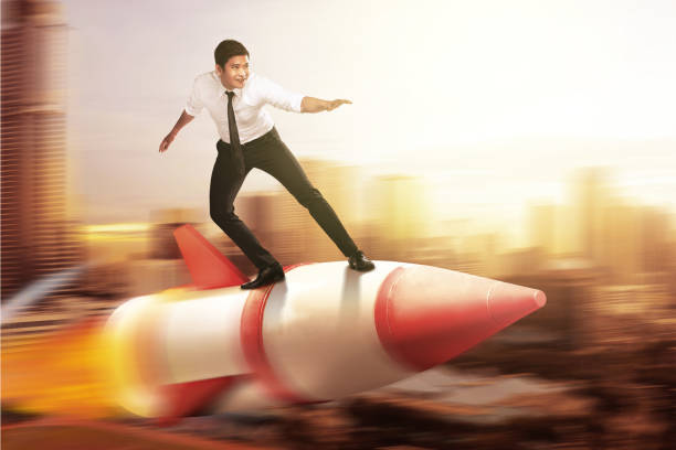 istock Asian businessman flying on a rocket 1259463523