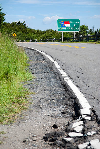 istock North Carolina state line and broken highway on Roan Mountain 125950583