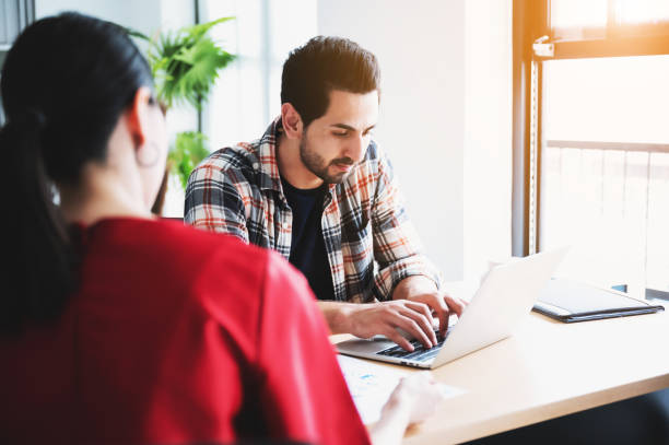 istock Coworking process, Corporate employees team working brainstorm project document sheet paperwork. Business startup company teamwork on meeting in modern office 1259531873