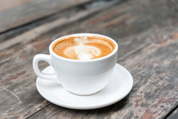 istock Hot coffee with late art on wooden table 1259540886