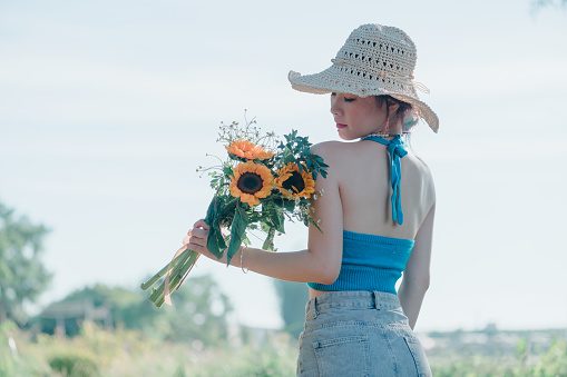 natural beauty girl with bouquet of flowers outdoor in freedom enjoyment concept