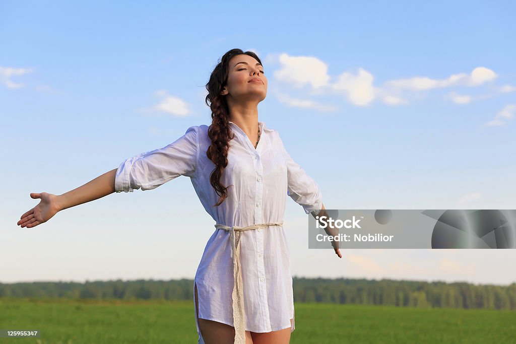 Young happy woman in green field Young happy woman breathing a fresh clean air in green field Activity Stock Photo