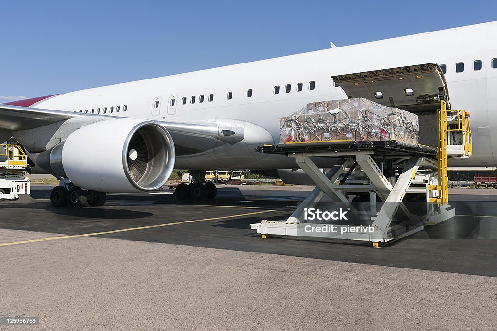 Loading freigth in airplane Goods are loaded on the plane Airplane Stock Photo