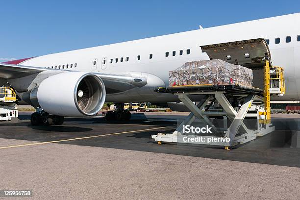 Loading Freigth In Airplane Stock Photo - Download Image Now - Airplane, Loading, Shipping