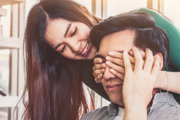 istock Happy Asian couple play covering eyes. 1259607335