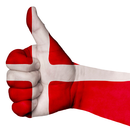 Hand with thumb up, Denmark flag painted as symbol of excellence, achievement, good - isolated on white background