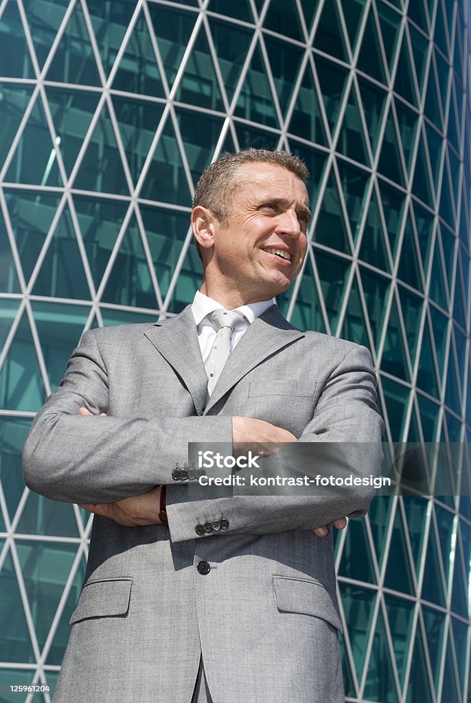 Businessman in a successful mood Businessman in a successful mood standing in front of an office building. 40-44 Years Stock Photo
