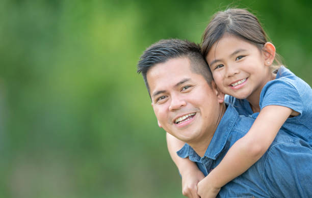istock Family smiling outside together 1259612921