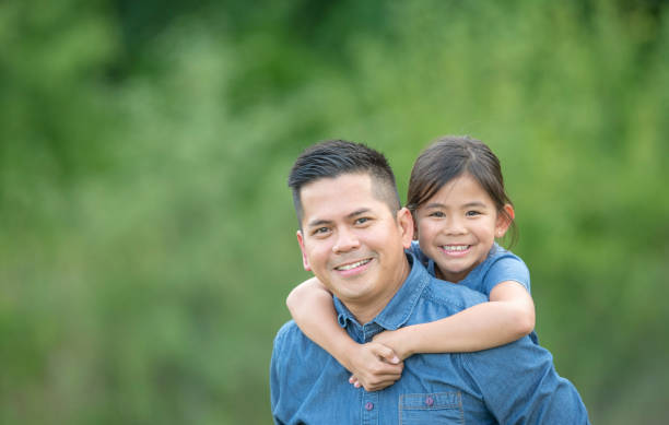 istock Family smiling outside together 1259612923