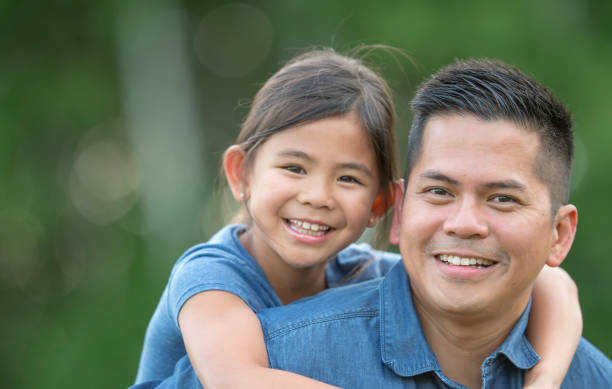istock Family smiling outside together 1259612924