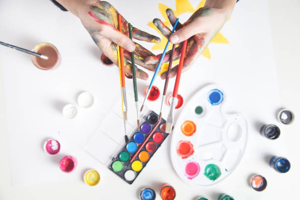 istock Girl painter holding lots of brushes. 1259616063