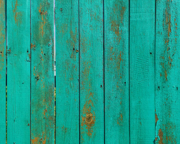 istock Green wood texture background. .Old ragged painted fence. 1259628813