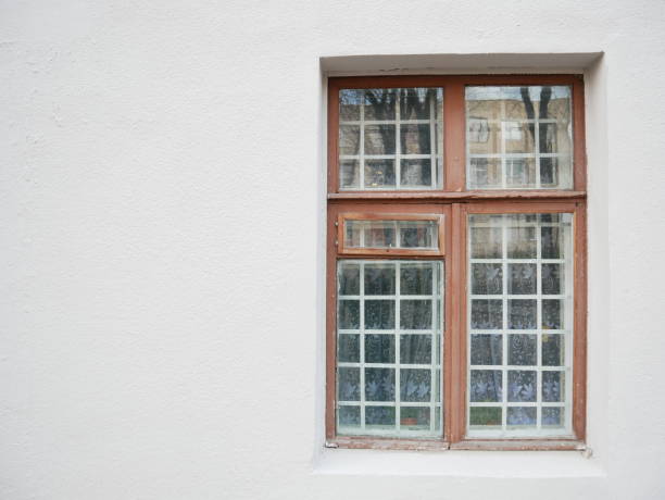 istock Old wooden window with metal grid. 1259633032