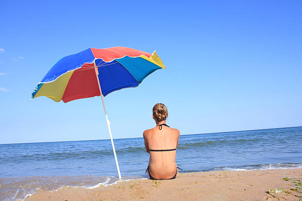 istock Girl on the beach with parasol 125964559