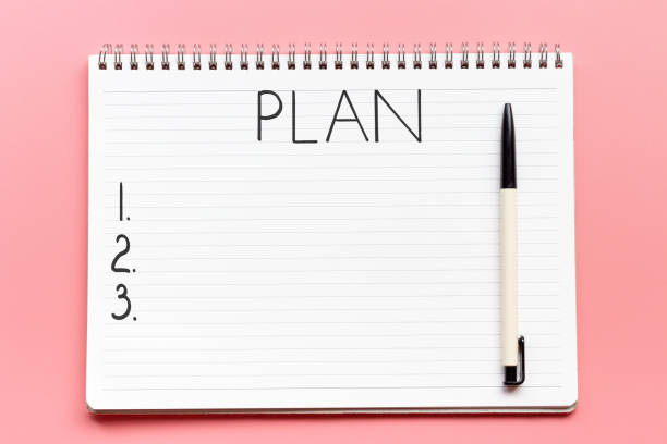 istock Notebook, business planning and pen on pink background, view from above 1259646453