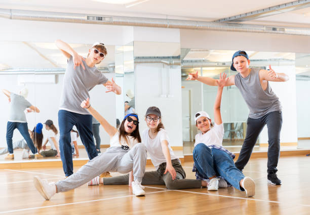 istock Group of dancing teenagers posing in dance studio 1259700083