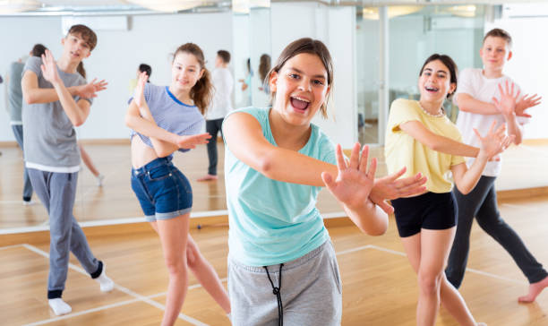 istock Diligent friendly smiling teenagers learn dance movements 1259700182