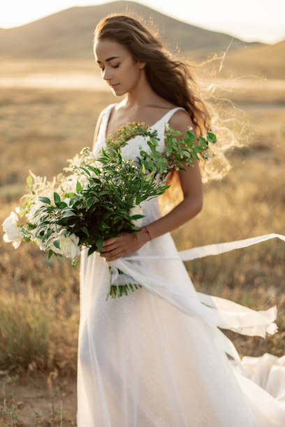 istock Attractive and tender bride with a luxurious large wedding bouquet 1259734863