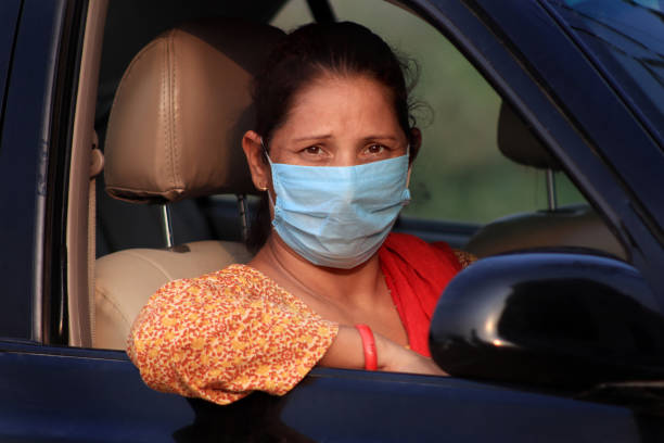 istock Female car driving wearing protective face mask while driving 1259738583