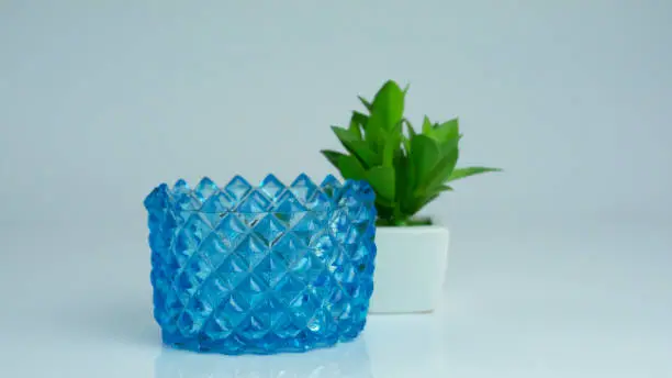 Blue Crystal Fruit Bowl with decorative item and floor reflection