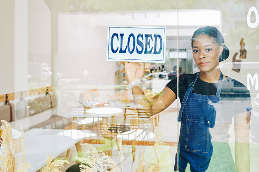 Sad young Black small business owner has to close her cafe due economic crisis