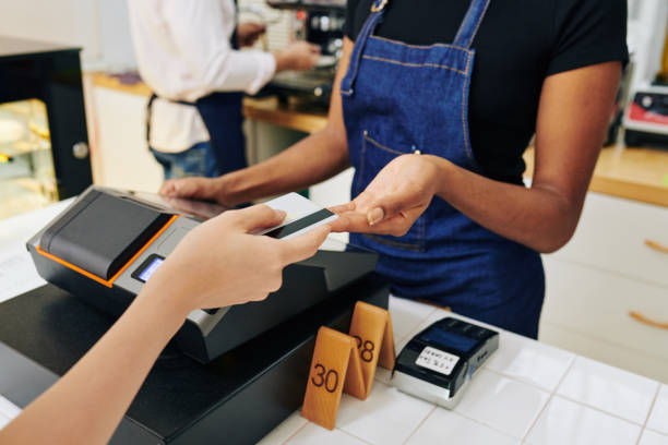 istock Customer paying with credit card 1259766804