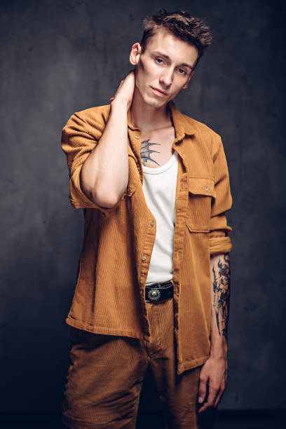istock Confident young caucasian man on dark background 1259767370