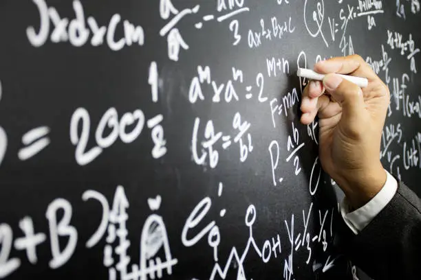 Mathematical concepts. The teacher explained math problems to students by writing intelligence problems on the blackboard.