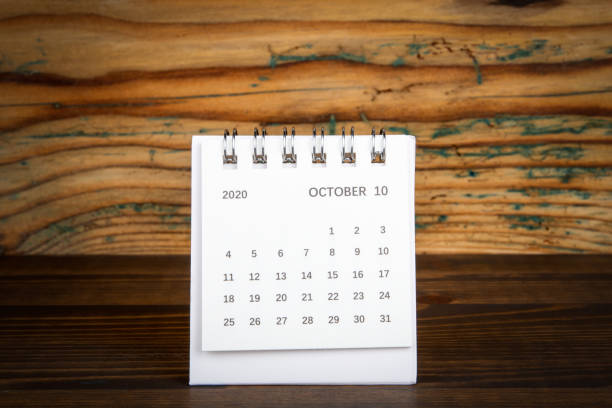 istock 2020 OCTOBER. White paper calendar on a wooden table. Time planning 1259774283