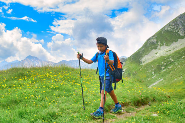 Woman with child during alpine trekking in summer