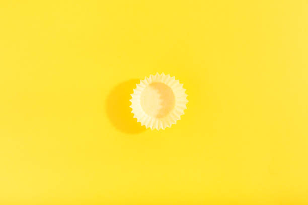 istock Trendy pattern made with yellow cap on bright yellow background. 1259788773