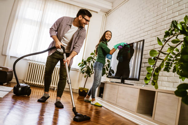 istock Couple cleaning at home 1259795322