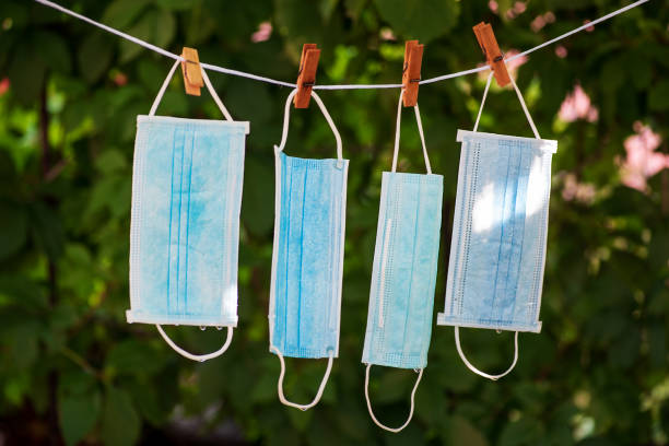 istock Washed wet surgical face masks drying in the backyard 1259812327