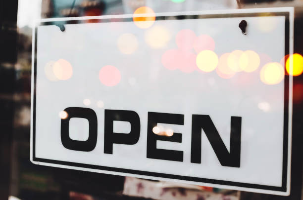 istock Open sign broad hanging on door front of cafe. 1259822675