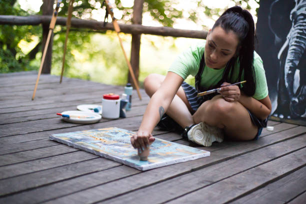 istock Female artist painting on canvas 1259847206