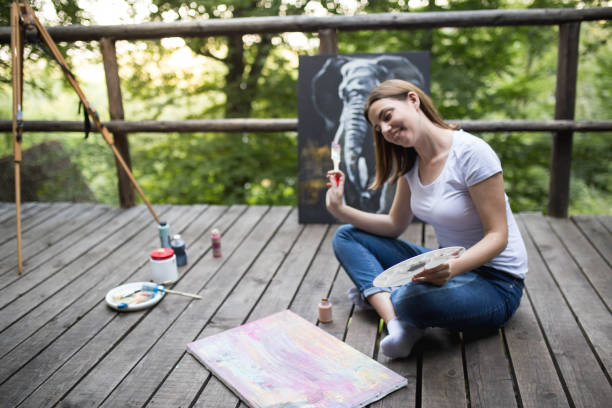 istock Creative woman painting on a canvas 1259859413