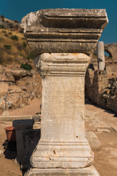 Close-up of a weathered stone slab featuring a Greek inscription from the Roman period, displayed in the Antalya Museum, Turkey. The text honors the people and council, referencing the archon Antiokhos Filopator and a dedication by Likos for peace and goodwill. The carved uppercase letters and aged surface reflect the civic and ceremonial traditions of ancient Anatolian cities under Roman influence. Ideal for historical, archaeological, and epigraphic studies.
