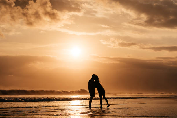 istock Attractive man and woman enjoying romantic evening on sunset 1259875227