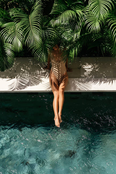 istock Young black woman relaxing at spa pool. 1259875614