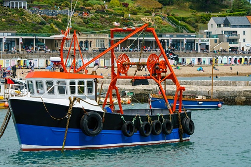 FISHING BOATS AT LYME REGIS IN DORSET ON A SUMMERS DAY