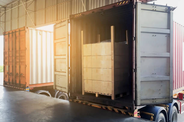 istock Truck container docking warehouse load cargo shipment at distribution warehouse, Cargo freight delivery industry warehouse transportation. 1259887392