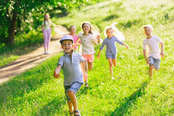 istock Kids, children running on meadow in summer's sunlight 1259890629