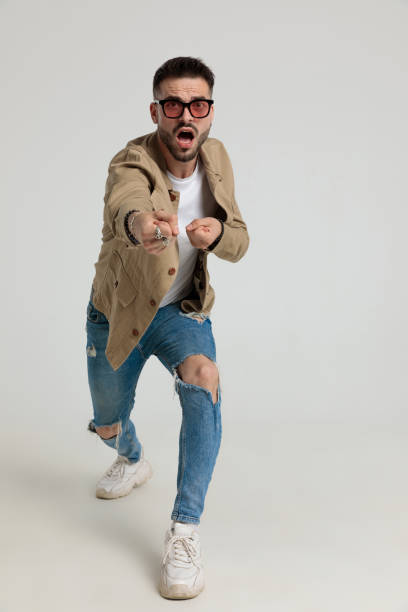 istock nervous young casual guy in jacket pulling the rope 1259896082