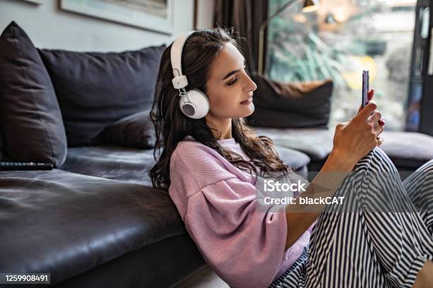Young Woman Enjoying At Home Stock Photo - Download Image Now - Podcasting, Listening, Music