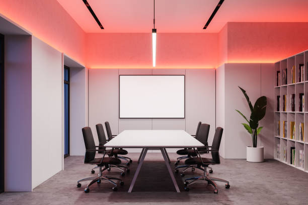 istock White meeting room with mock up poster at night 1259910284