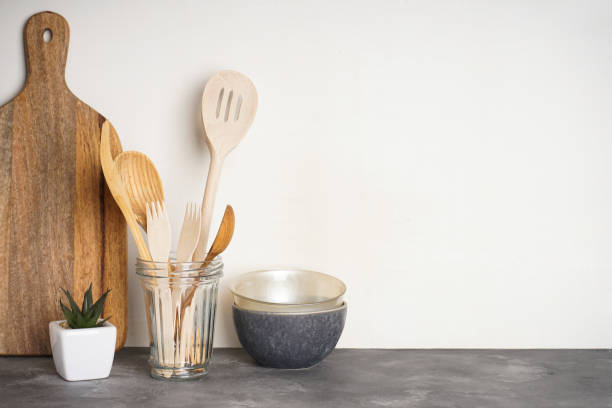 istock Wooden kitchen utensils in a glass on a gray background with space for text. 1259912585