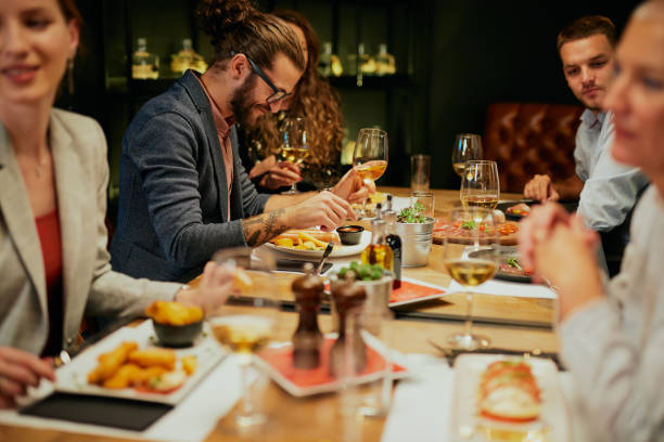 istock Group of friends having fun at restaurant. 1259913107
