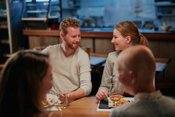 istock Group of friends having fun at restaurant. 1259913117